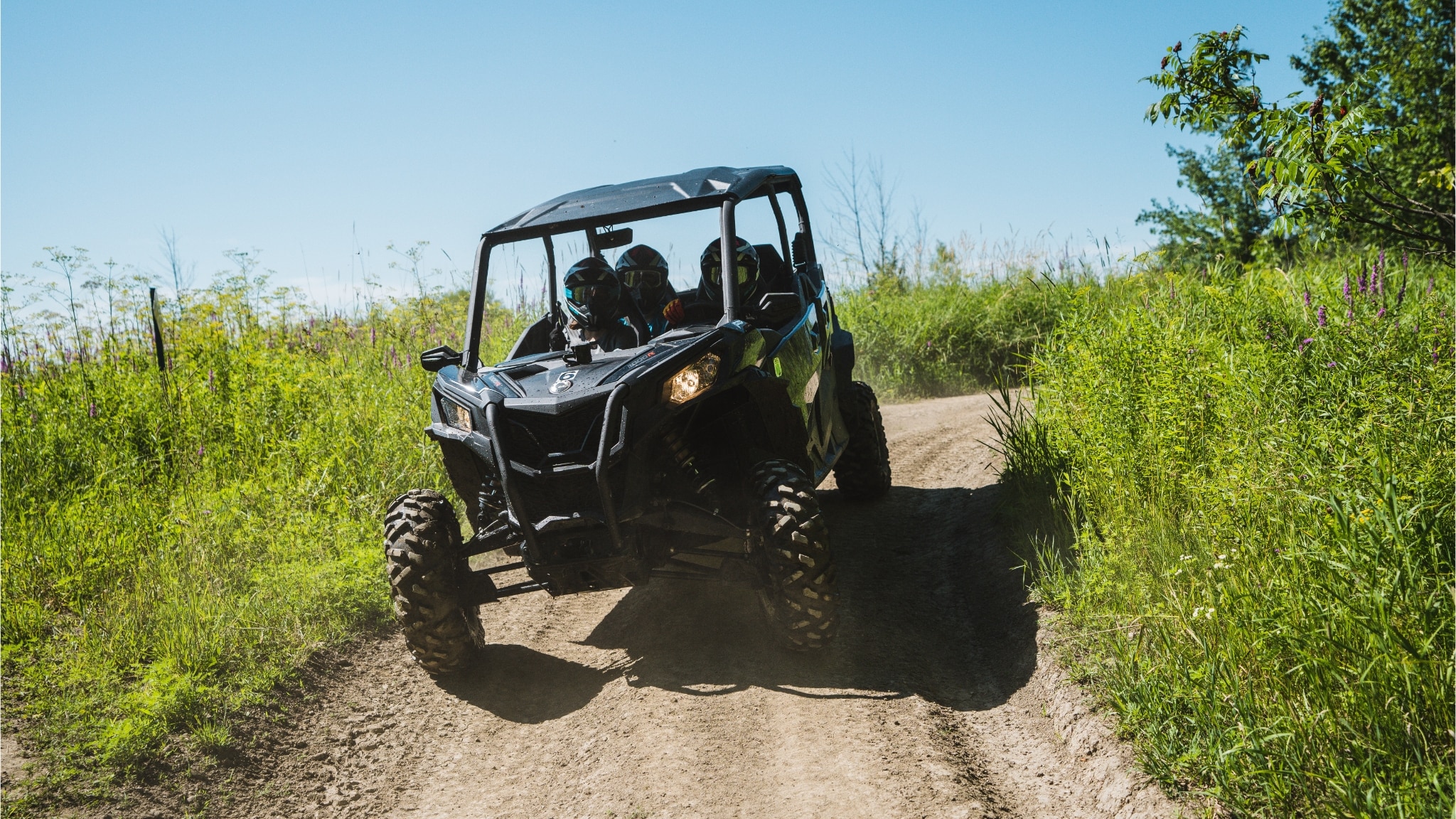 Can-Am Defender SxS riding in a field