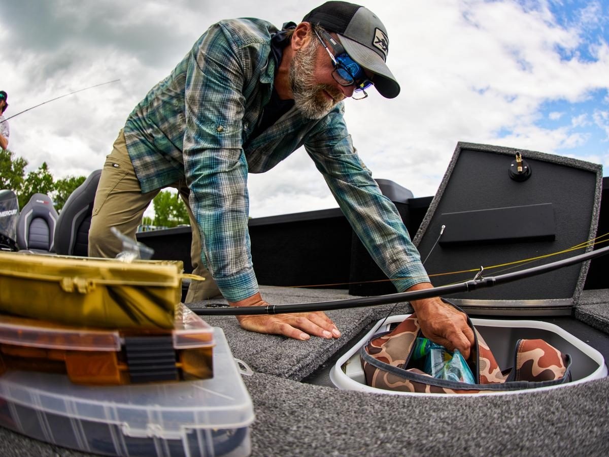 A fisherman using the dry storage space of Alumacraft Trophy & Competitor boats