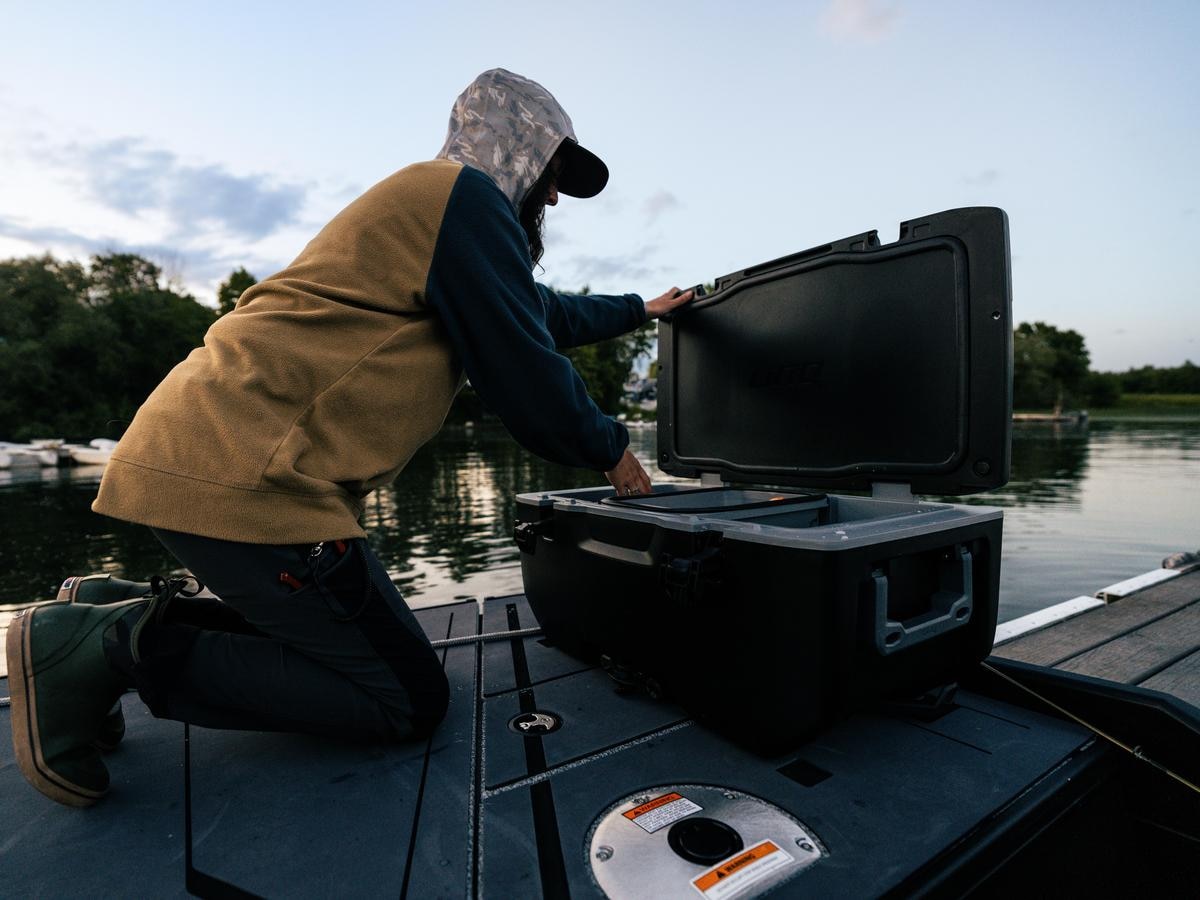 An angler using the max deck to store his fish in a LinQ cooler