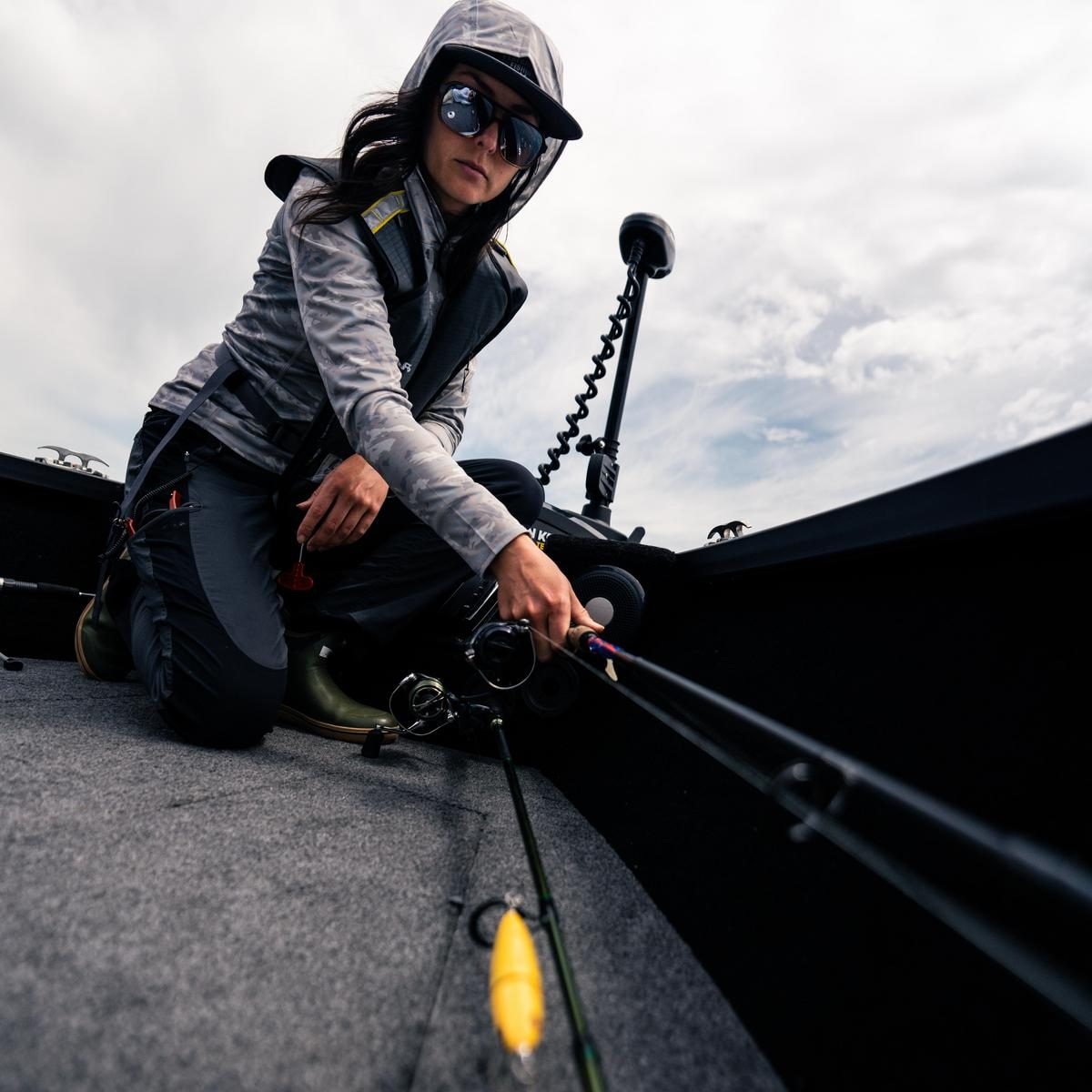 A fisherwoman using the rod storage space of Alumacraft Trophy & Competitor boats