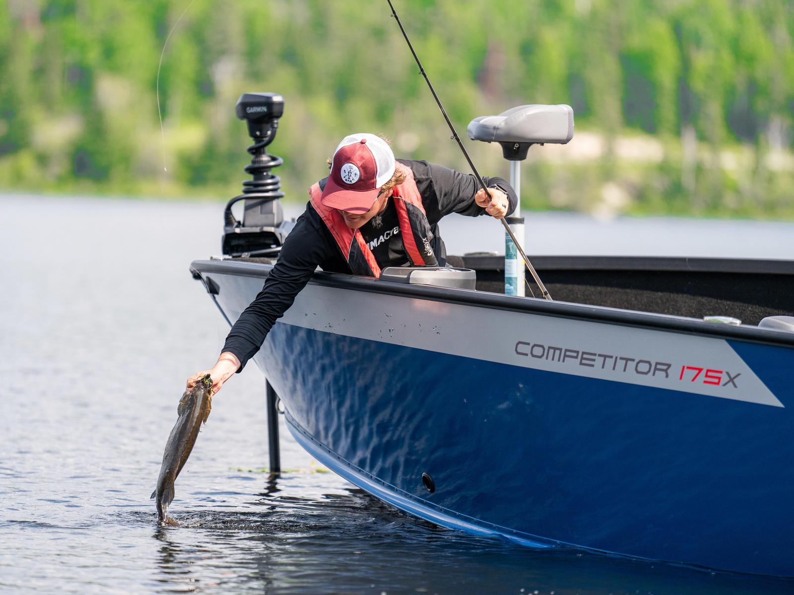 Ambassador Jay Siemens pulling a fish out of the water on his Alumacraft Competitor 2025