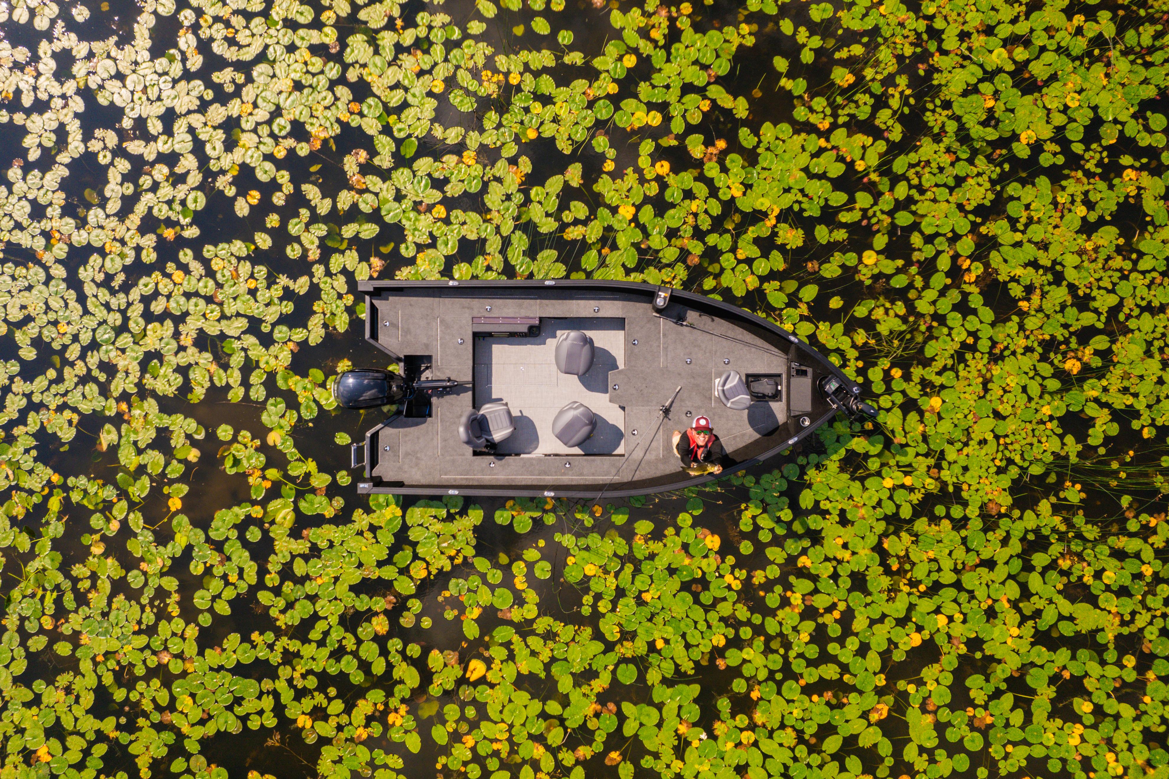 Aerial view of a new 2025 Alumacraft Competitor surrounded by water lilies