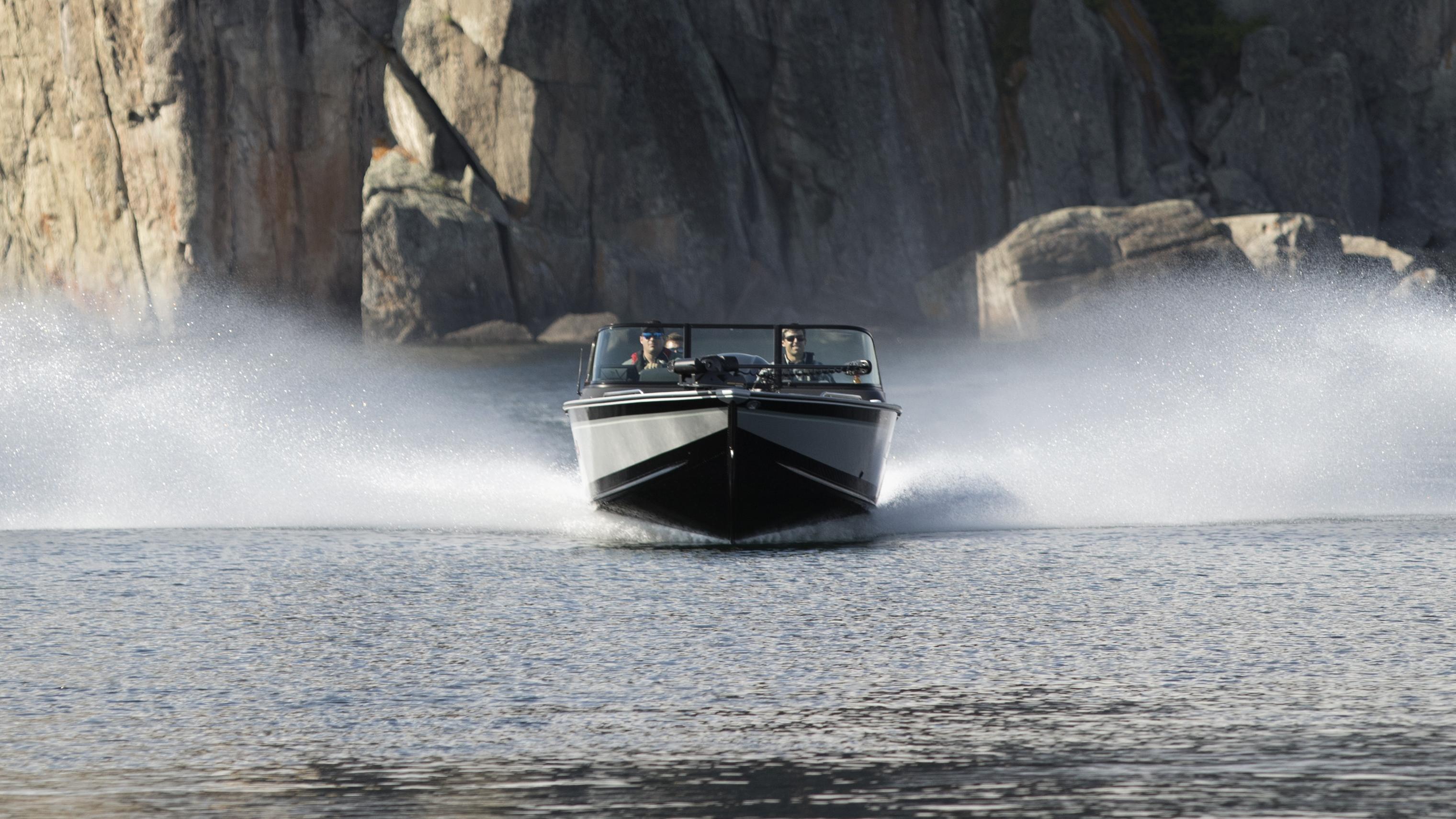 A group sailing in open water on the new white and grey Alumacraft Trophy 2025.