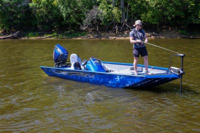 Male Angler Fishes From Front of Blue Pro 185 Bass Boat