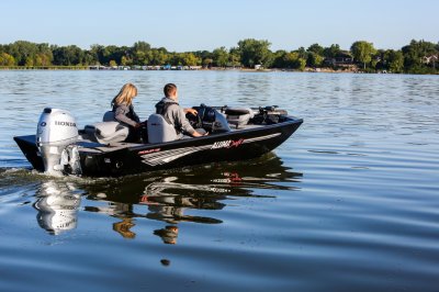 Man and Woman Anglers Driving A Black Alumacraft 175 Prowler Bass Boat