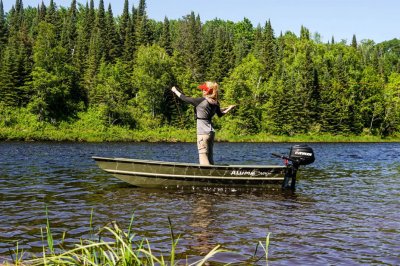 Female Angler Casting Fishing Rod Standing in 1036 Jon Boat